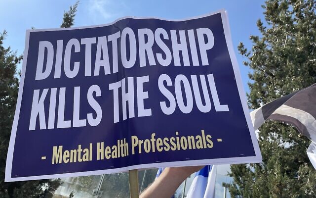 A sign held by a mental health professional in a protest against the government's planned judicial overhaul outside the Knesset in Jerusalem, March 27, 2023. (Renee Ghert-Zand) A sign held by a mental health professional in a protest against the government's planned judicial overhaul outside the Knesset in Jerusalem, March 27, 2023. (Renee Ghert-Zand)