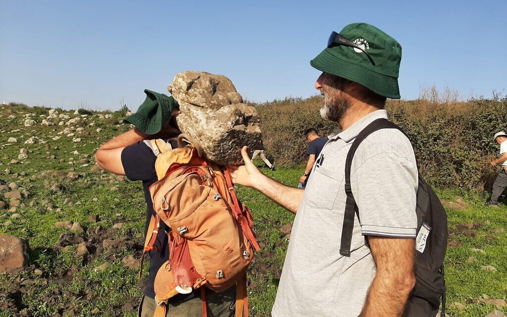 Students from the Kinneret Academic college help bring the 62-pound lioness carving from Ein Nashut to their bus on March 1, 2023, in the Golan Heights. (courtesy Mordechai Aviam) Students from the Kinneret Academic college help bring the 62-pound lioness carving from Ein Nashut to their bus on March 1, 2023, in the Golan Heights. (courtesy Mordechai Aviam)