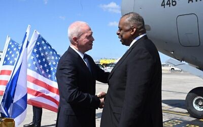 Defense Minister Yoav Gallant (left) greets US Defense Secretary Lloyd Austin at Ben Gurion Airport, March 2023. (Ariel Hermoni/Defense Ministry)
