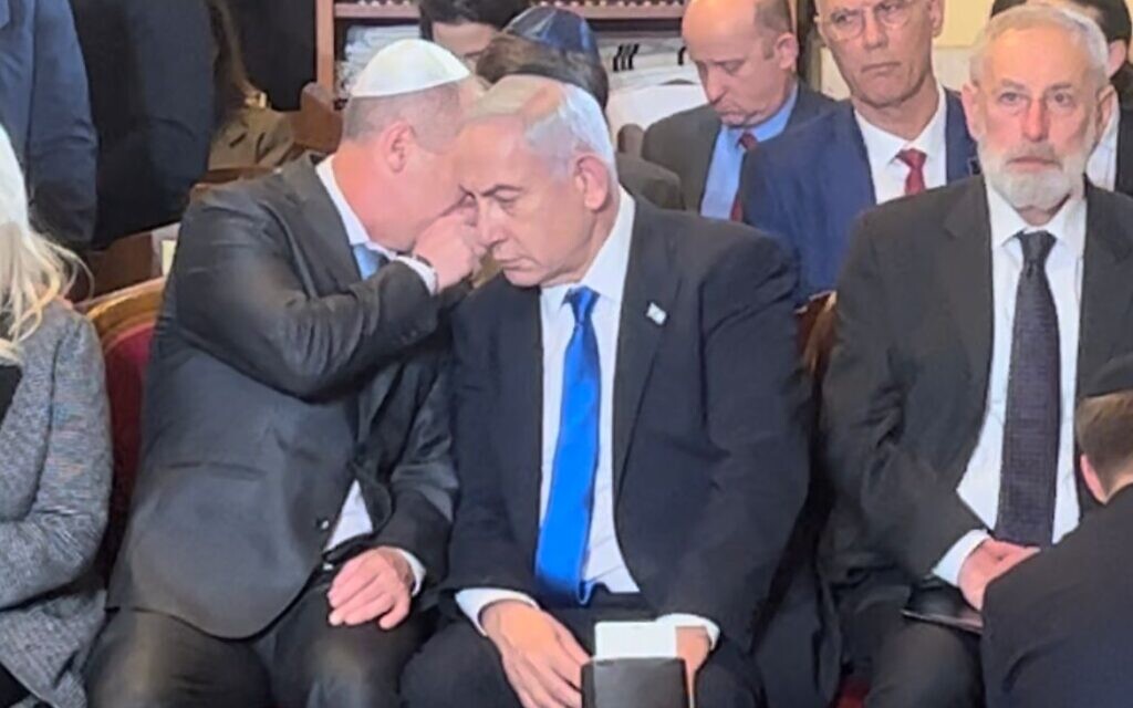Prime Minister Benjamin Netanyahu being informed of the terror attack in Tel Aviv while in a synagogue in Rome, March 9, 2023. (Lazar Berman/The Times of Israel) Prime Minister Benjamin Netanyahu being informed of the terror attack in Tel Aviv while in a synagogue in Rome, March 9, 2023. (Lazar Berman/The Times of Israel)