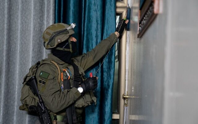 An Israeli soldier takes measurements at the home of Abdel Fattah Hussein Kharousha, a Hamas member accused of carrying out a deadly attack in Huwara, in the West Bank city of Nablus early March 22, 2023. (Israel Defense Forces) An Israeli soldier takes measurements at the home of Abdel Fattah Hussein Kharousha, a Hamas member accused of carrying out a deadly attack in Huwara, in the West Bank city of Nablus early March 22, 2023. (Israel Defense Forces)