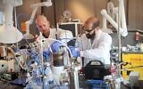 Helios scientists conduct an experiment to produce iron. (Courtesy, Helios)