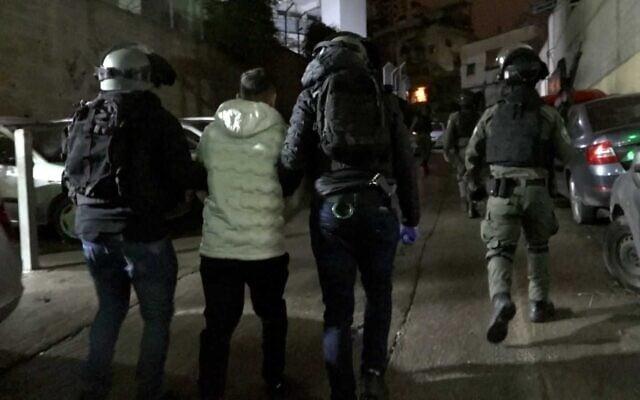 A man is arrested at an unspecified location as part of an undercover operation into illegal weapons, March 14, 2023 (Israel Police)