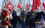 A demonstrator beats a swastika-emblazoned drum at a far-right march in Kaunas, Lithuania on February 16, 2015. (Canaan Lidor)
