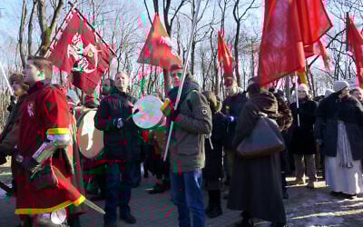 A demonstrator beats a swastika-emblazoned drum at a far-right march in Kaunas, Lithuania on February 16, 2015. (Canaan Lidor)