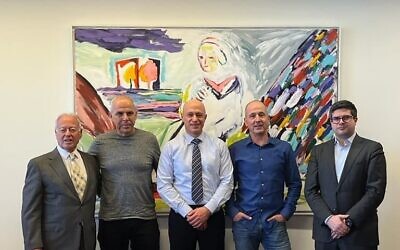 Yoram Naveh, Clal Insurance Finance CEO (middle) and Max chairman Yaron Bloch (second from left). (Courtesy)