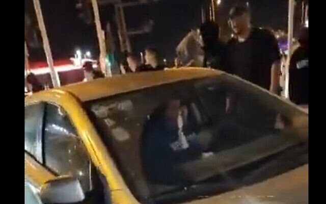 Right-wing activists accost drivers at the entrance to a kibbutz in northern Israel, March 27, 2023. (video screenshot; used in accordance with Clause 27a of the Copyright Law)