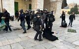 Israeli security forces remove Palestinian Muslim worshipers sitting on the grounds of the Al-Aqsa Mosque compound in Jerusalem, early on April 5, 2023. (Ahmad Gharabli/AFP)