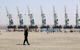 Illustrative: An Iranian police officer walks at Shahid Beheshti Port in the southeastern Iranian coastal city of Chabahar, February 25, 2019. (ATTA KENARE / AFP)