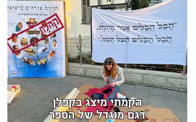 Yuli Yavin, 18, protests against the high school civics textbook 'Being an Israeli Citizen' in Tel Aviv, March 2023. (Twitter video screenshot: used in accordance with Clause 27a of the Copyright Law) Yuli Yavin, 18, protests against the high school civics textbook 'Being an Israeli Citizen' in Tel Aviv, March 2023. (Twitter video screenshot: used in accordance with Clause 27a of the Copyright Law)