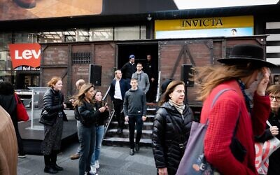 Visitors disembark a replica Holocaust-era cattle car on Holocaust Remembrance Day, in New York City, April 18, 2023. (Luke Tress/Times of Israel)