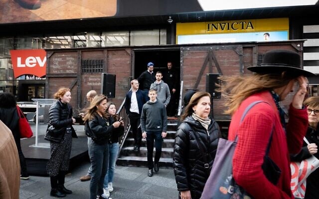 Visitors disembark a replica Holocaust-era cattle car on Holocaust Remembrance Day, in New York City, April 18, 2023. (Luke Tress/Times of Israel) Visitors disembark a replica Holocaust-era cattle car on Holocaust Remembrance Day, in New York City, April 18, 2023. (Luke Tress/Times of Israel)