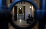 Illustrative: Police officers wait outside a court room in Vienna, on October 18, 2022. ( JOE KLAMAR / AFP)