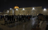 Palestinian Muslims perform the 'Tarawih' evening prayer outside the Dome of the Rock shrine in Jerusalem's al-Aqsa Mosque compound atop the Temple Mount during the holy month of Ramadan, on April 8, 2023. (AHMAD GHARABLI / AFP)