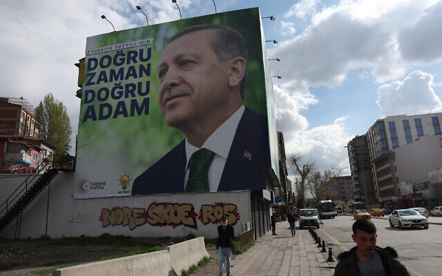 Pedestrians walk past billboards showing the portrait of Turkish President Tayyip Erdogan and a slogan reading "For Turkey's century; the right time, the right man," on a building in Ankara ahead of the May 14 presidential and parliamentary elections, on April 20, 2023. (Adem Altan/AFP) Pedestrians walk past billboards showing the portrait of Turkish President Tayyip Erdogan and a slogan reading "For Turkey's century; the right time, the right man," on a building in Ankara ahead of the May 14 presidential and parliamentary elections, on April 20, 2023. (Adem Altan/AFP)