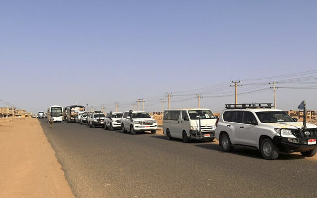 A convoy leaving Khartoum advances on a road towards Port Sudan, on April 23, 2023, as people flee the battle-torn Sudanese capital. (Abubakarr JALLOH / AFP)