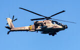 An Israeli Air Force AH-64D Apache attack helicopter flies over during an air show in Tel Aviv on April 26, 2023, as Israel marks Independence Day. (JACK GUEZ/AFP)