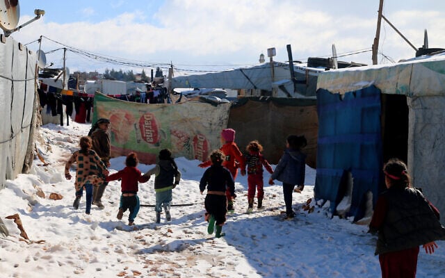 File: Syrian children run through the snow in the Syrian refugee camp of al-Hilal in the village of al-Taybeh near Baalbek in Lebanon's Bekaa valley, on January 20, 2022. (AFP) File: Syrian children run through the snow in the Syrian refugee camp of al-Hilal in the village of al-Taybeh near Baalbek in Lebanon's Bekaa valley, on January 20, 2022. (AFP)