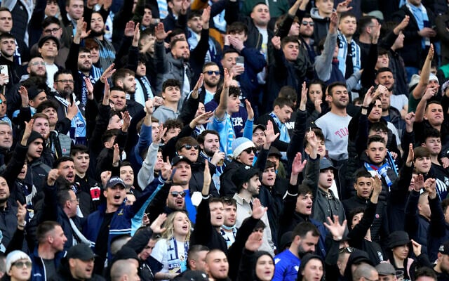 Lazio fans cheer before the start of a Serie A soccer match between Roma and Lazio at Rome's Olympic stadium, March 20, 2022. (AP Photo/Andrew Medichini) Lazio fans cheer before the start of a Serie A soccer match between Roma and Lazio at Rome's Olympic stadium, March 20, 2022. (AP Photo/Andrew Medichini)