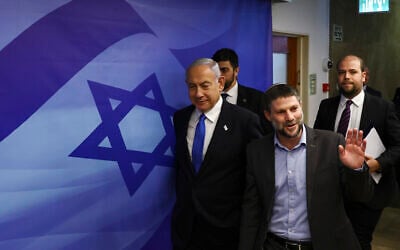Prime Minister Benjamin Netanyahu, left, and Finance Minister Bezalel Smotrich, right, arrive to attend a cabinet meeting at the Prime Minister's office in Jerusalem, Feb. 23, 2023. (Ronen Zvulun/Pool Photo via AP)