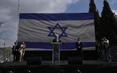 Yair Lapid, leader of the opposition's Yesh Atid party, addresses Israelis protesting against Prime Minister Benjamin Netanyahu's judicial overhaul plan, outside the Knesset in Jerusalem, March 27, 2023. (AP Photo/Ohad Zwigenberg)