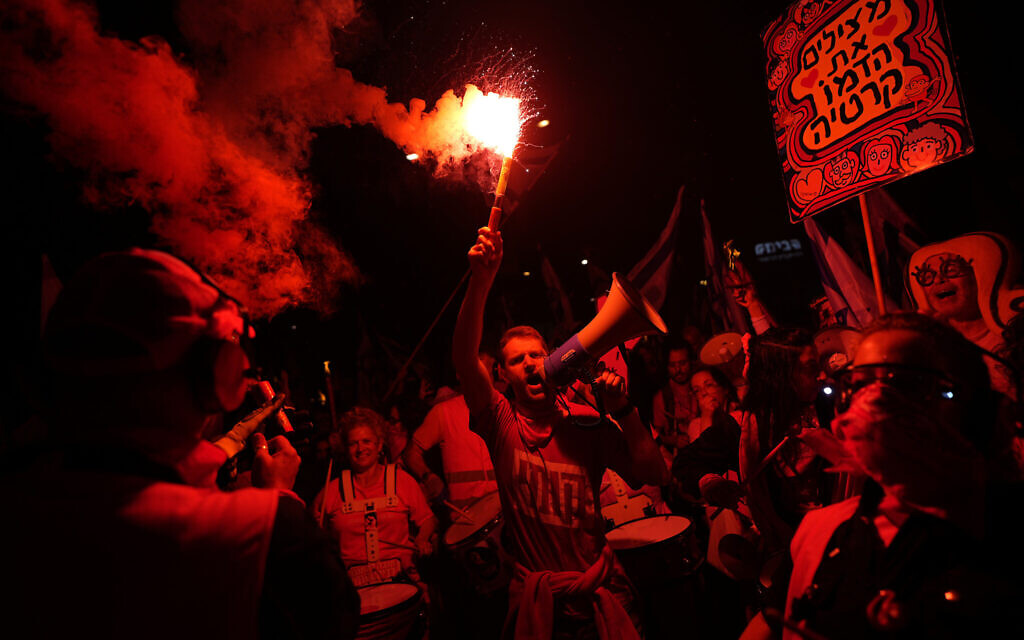 Israelis protest plans by Prime Minister Benjamin Netanyahu's hard-right government to overhaul the judicial system, in Tel Aviv, Saturday, April 1, 2023. (AP Photo/Ohad Zwigenberg)