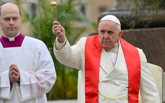 Pope Francis blesses faithful with olive and palm branches before celebrating the Palm Sunday's mass in St. Peter's Square at The Vatican, April 2, 2023. (AP Photo/Filippo Monteforte, pool)