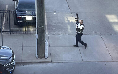 This photo provided by Reid Cornell shows police presence near the scene of a shooting in Louisville, Kentucky, April 10, 2023. (Reid Cornell via AP)