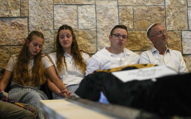The husband and children of Lucy Dee, 48, who was killed in a West Bank terror shooting attack, attend her funeral at the Gush Etzion Regional Cemetery in Kfar Etzion on April 11, 2023. (AP Photo/Maya Alleruzzo)