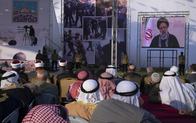 Palestinians watch a pre-recorded speech by Iranian President Ebrahim Raisi on "Jerusalem Day," which is called al-Quds Day after the city's Arabic name, at a soccer filed in Gaza City, Friday, April 14, 2023. (AP Photo/Fatima Shbair) Palestinians watch a pre-recorded speech by Iranian President Ebrahim Raisi on "Jerusalem Day," which is called al-Quds Day after the city's Arabic name, at a soccer filed in Gaza City, Friday, April 14, 2023. (AP Photo/Fatima Shbair)