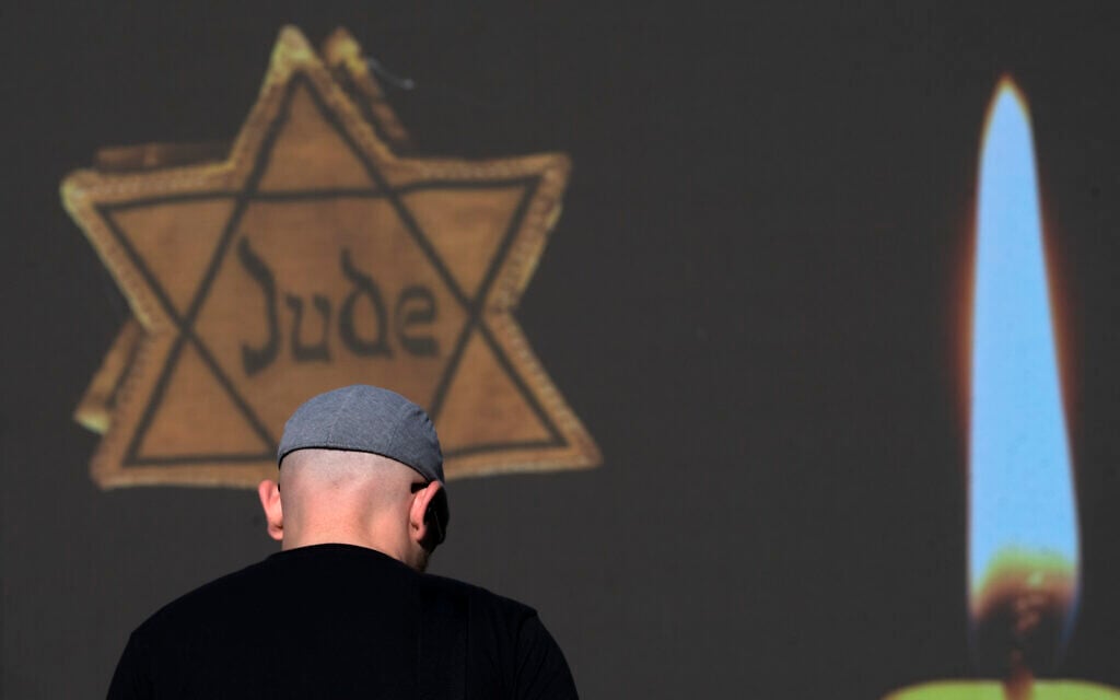 Illustrative: A man walks by a billboard showing a yellow Star of David that reads 'Jude,' Jew in German. (AP Photo/ Oded Balilty) Illustrative: A man walks by a billboard showing a yellow Star of David that reads 'Jude,' Jew in German. (AP Photo/ Oded Balilty)