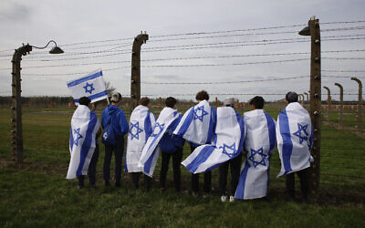 People participate in the annual 'March of the Living', a trek between two former Nazi-run death camps, in Oswiecim, Poland, on April 18, 2023 to mourn victims of the Holocaust and celebrate the existence of the Jewish state. (AP Photo/Michal Dyjuk) People participate in the annual 'March of the Living', a trek between two former Nazi-run death camps, in Oswiecim, Poland, on April 18, 2023 to mourn victims of the Holocaust and celebrate the existence of the Jewish state. (AP Photo/Michal Dyjuk)