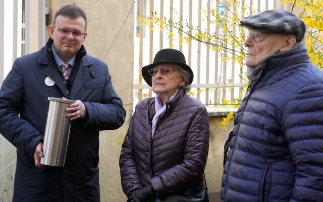 Albert Stankowski, left, the director of the Warsaw Ghetto Museum, Anna Stupnicka-Bando, center, a Polish Christian honored for saving Jews, and Waclaw Kornblum, right, a Polish Holocaust survivor, attend a ceremony for the burial of a 'time capsule' on the grounds of the museum in Warsaw, Poland, on April 18, 2023. (Czarek Sokolowski/AP) Albert Stankowski, left, the director of the Warsaw Ghetto Museum, Anna Stupnicka-Bando, center, a Polish Christian honored for saving Jews, and Waclaw Kornblum, right, a Polish Holocaust survivor, attend a ceremony for the burial of a 'time capsule' on the grounds of the museum in Warsaw, Poland, on April 18, 2023. (Czarek Sokolowski/AP)