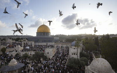 Palestinians attend Eid al-Fitr holiday celebrations by the Dome of the Rock shrine in the Al Aqsa Mosque compound on the Temple Mount in Jerusalem's Old City, April 21, 2023. (AP Photo/ Mahmoud Illean)