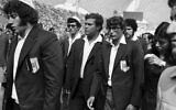Members of Israel's Olympic team place black ribbons in their pockets after a memorial service mourning their comrades killed in the terrorist attack and subsequent police shoot-out, leave the Olympic stadium in Munich, then West Germany, September 6, 1972. (AP Photo, File)