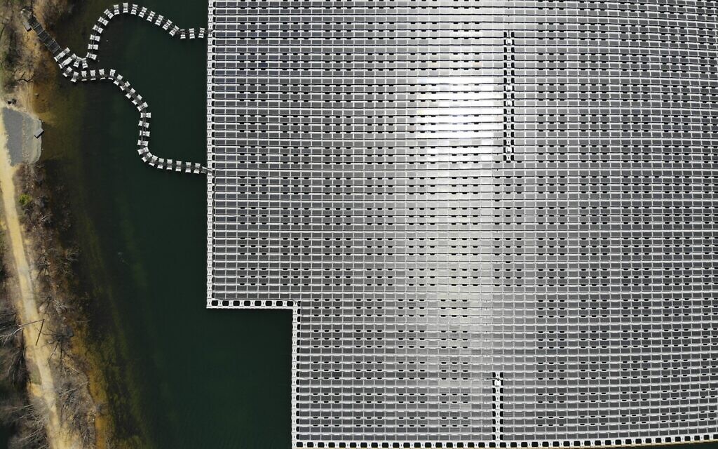 An array of solar panels float on top of a water storage pond in Sayreville, N.J., Monday, April 10, 2023. (AP/Seth Wenig)