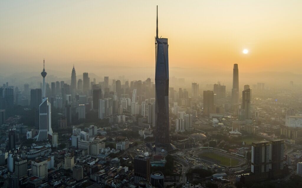 The sun rises over downtown Kuala Lumpur, Malaysia on April 11, 2023. (AP/Vincent Thian)