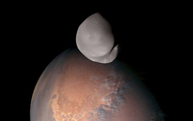 This image provided by the UAE Space Agency shows the planet Mars and its moon, Deimos, in the foreground. The United Arab Emirates’ Amal spacecraft - Arabic for Hope - flew within 62 miles of Deimos in March 2023. (UAE Space Agency via AP) This image provided by the UAE Space Agency shows the planet Mars and its moon, Deimos, in the foreground. The United Arab Emirates’ Amal spacecraft - Arabic for Hope - flew within 62 miles of Deimos in March 2023. (UAE Space Agency via AP)