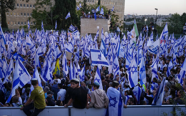 Right-wing Israelis wave their national flag during a rally in support of plans by Prime Minister Benjamin Netanyahu's government to overhaul the judicial system, outside the Knesset, Israel's parliament in Jerusalem, Thursday, April 27, 2023. (AP Photo/Ohad Zwigenberg)