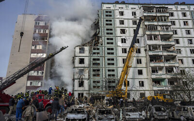 Firefighters work to extinguish a fire after a Russian attack at a residential building in Uman, central Ukraine, April 28, 2023. (AP Photo/Bernat Armangue)