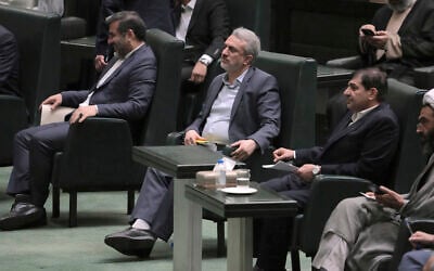 Iranian Industries Minister Reza Fatemi Amin, center, listens during an open session of parliament for his impeachment, in Tehran, Iran, April 30, 2023. (AP Photo/ Vahid Salemi)