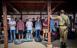 File: Young Israelis line up at an army recruitment center at Tel Hashomer, outside of Tel Aviv, on July 25, 2016. (Miriam Alster/Flash90)