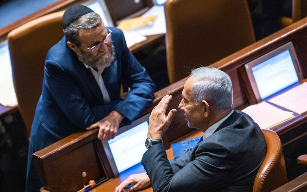 Likud's Benjamin Netanyahu, right, with UTJ MK Moshe Gafni in the Knesset on December 28, 2022. (Olivier Fitoussi/Flash90)