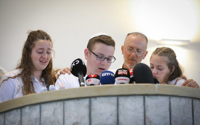 The husband and children of Lucy Dee, 48, who was killed in a West Bank shooting attack, attend her funeral at the Gush Etzion Regional Cemetery in Kfar Etzion on April 11, 2023. (Noam Revkin Fenton/Flash90)