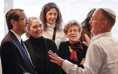 President Isaac Herzog (left) speaks with Rabbi Leo Dee (right), during a condolence visit to his family's home in the West Bank settlement of Efrat, April 13, 2023. (Gershon Elinson/Flash90)