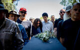 Friends and family mourn renowned author Meir Sahlev at his funeral in Nahalal cemetery, northern Israel, April 14, 2023. (Shir Torem/Flash90)