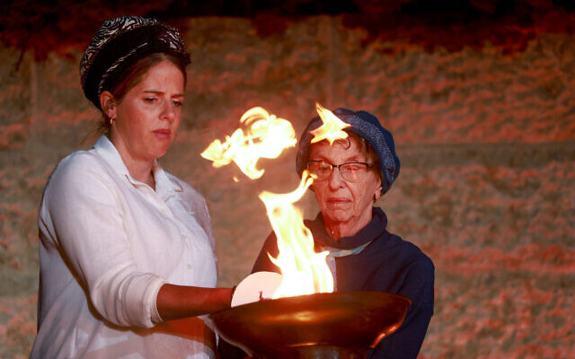 A Holocaust survivor lights one of six torches representing the six million victims of the Nazi genocide, during the opening ceremony, at the Yad Vashem Holocaust Memorial Museum in Jerusalem, of Israel's annual Holocaust Remembrance Day, April 17, 2023. (Eric Marmor/Flash90)