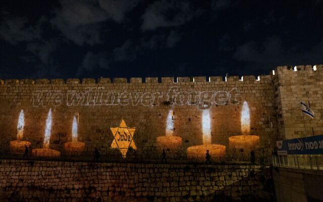 Candles in honour of the six million Jews killed in the Holocaust light up the Old City Walls in Jerusalem, as Israel marks Holocaust Remembrance Day. April 17, 2023. (Yonatan Sindel/Flash90)