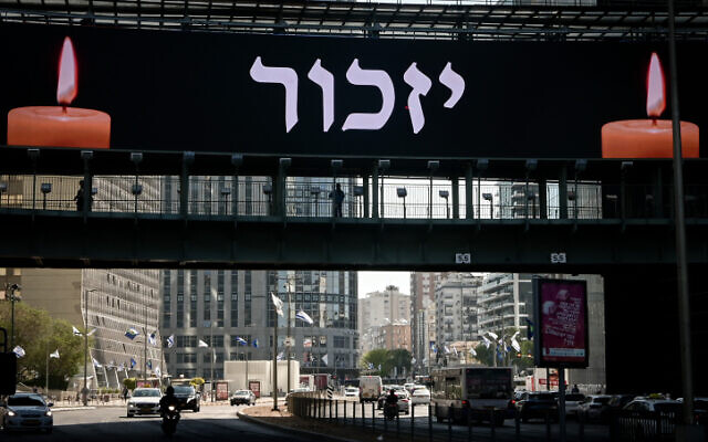 A large banner reading 'Remember' hangs in Tel Aviv on Memorial Day, April 25, 2023. (Avshalom Sassoni/Flash90) A large banner reading 'Remember' hangs in Tel Aviv on Memorial Day, April 25, 2023. (Avshalom Sassoni/Flash90)