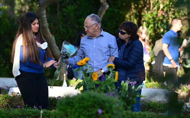 Family members and friends visit the graves of fallen soldiers at the Kiryat Shaul Military Cemetery in Tel Aviv on Memorial Day, April 25, 2023. (Tomer Neuberg/Flash90) Family members and friends visit the graves of fallen soldiers at the Kiryat Shaul Military Cemetery in Tel Aviv on Memorial Day, April 25, 2023. (Tomer Neuberg/Flash90)
